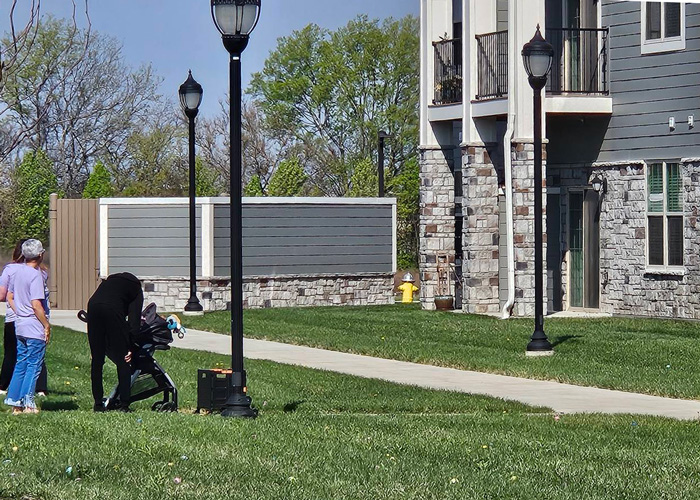 Sidewalk view of The Princeton Senior Living with residents spending time outdoors in spring weather.