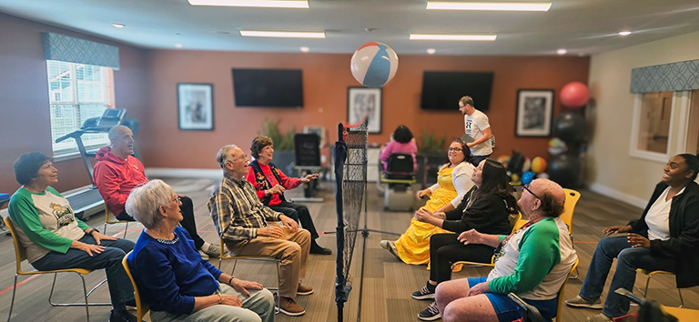 A spirited game of chair beachball volleyball being played in the fitness center at The Princeton.