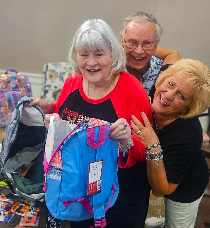 Resident Ambassadors smile and laugh together, helping out during a community event at The Princeton.